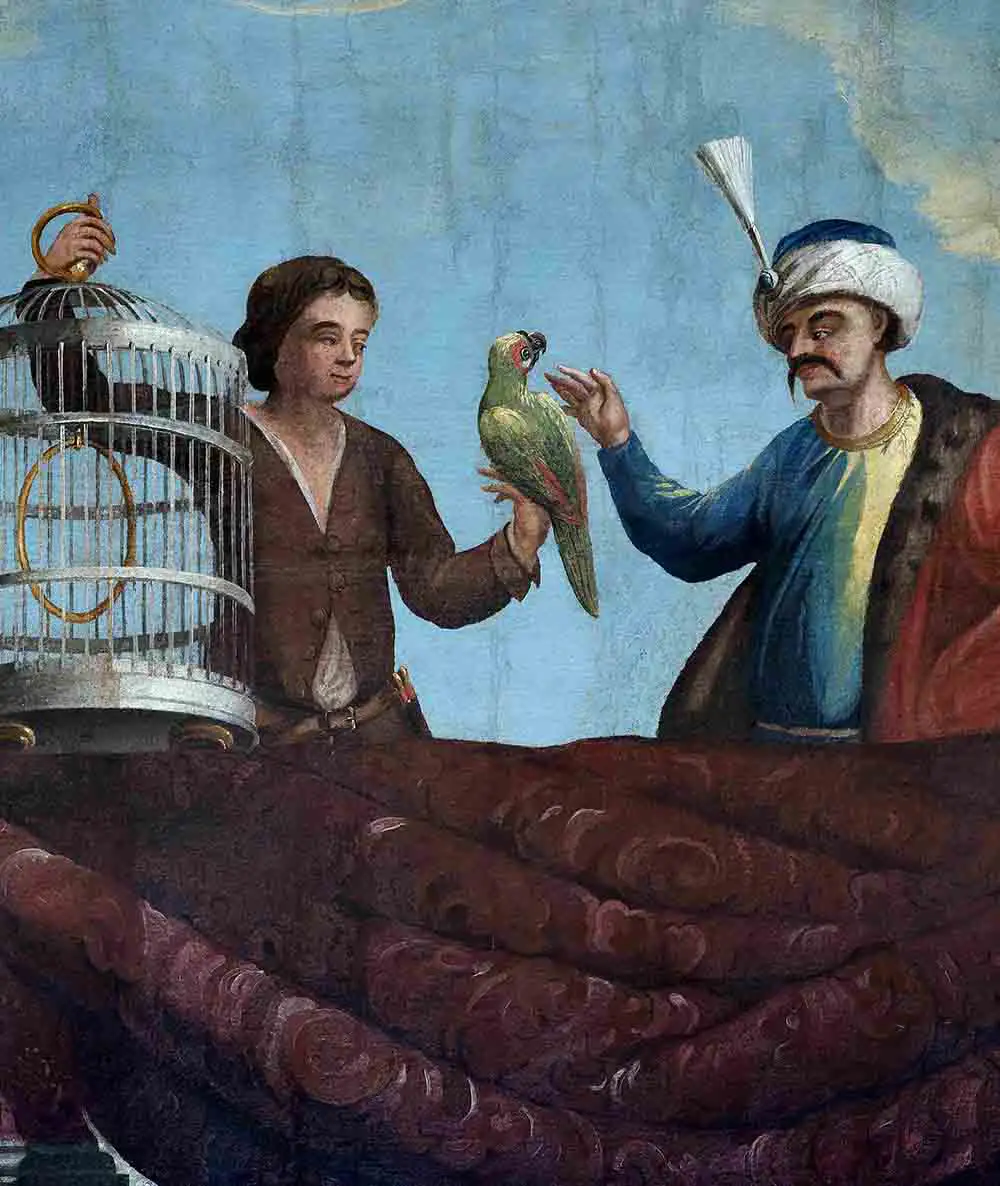 
                   Historische Darstellung eines Mannes mit einem Papagei auf der Hand und einem anderen Mann, der einen Vogelkäfig hält, in traditioneller Kleidung vor einem blauen Himmel.
                   